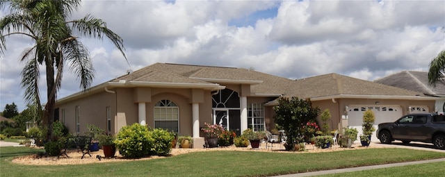 view of front of house featuring a front yard and a garage