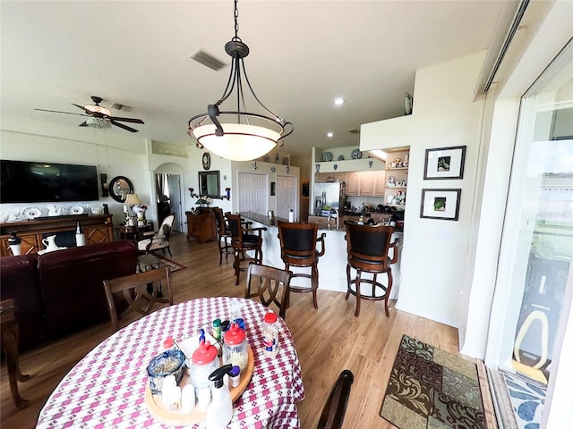 dining room featuring light hardwood / wood-style floors and ceiling fan