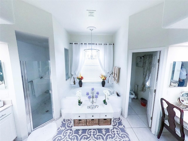 full bathroom with separate shower and tub, vanity, tile patterned flooring, an inviting chandelier, and toilet