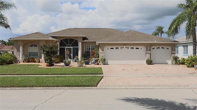 view of front of house with a front lawn and a garage