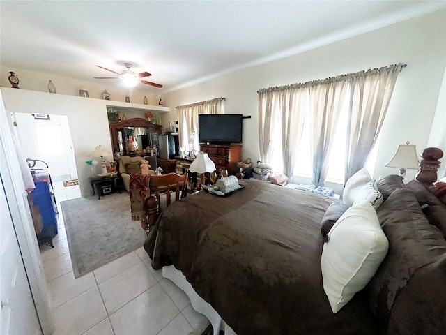 bedroom with ceiling fan and light tile patterned flooring