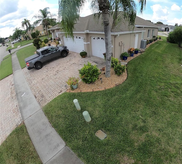 single story home featuring a front lawn and a garage