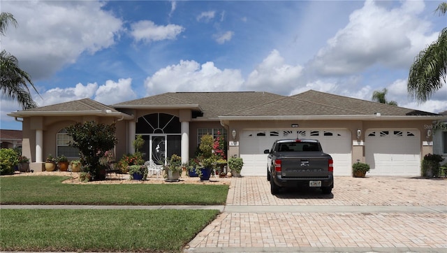 single story home with a front lawn and a garage