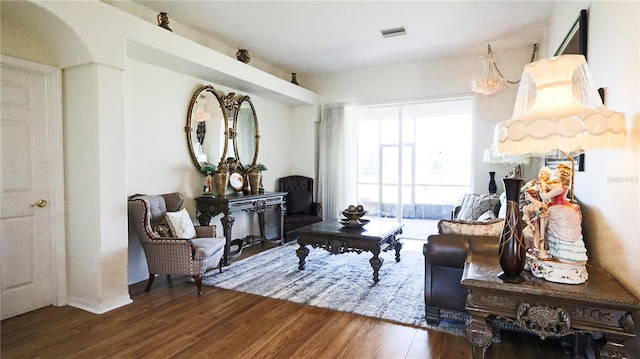 sitting room with wood-type flooring