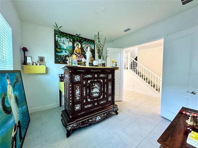 interior space featuring stairs, visible vents, and baseboards