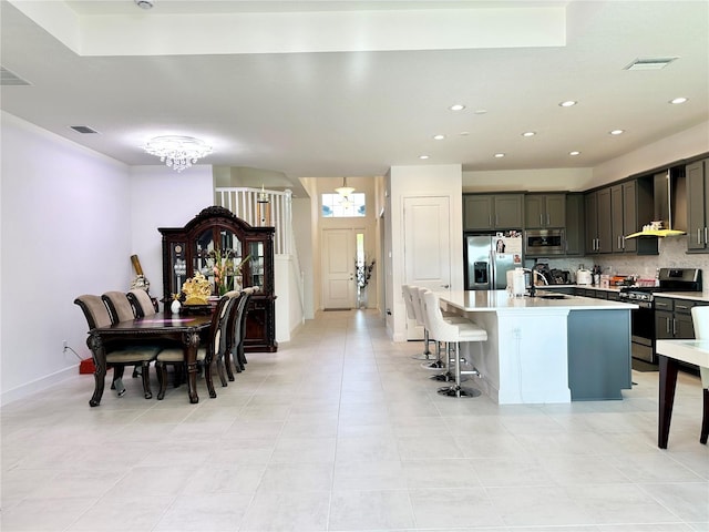 dining space with baseboards, visible vents, a chandelier, and recessed lighting