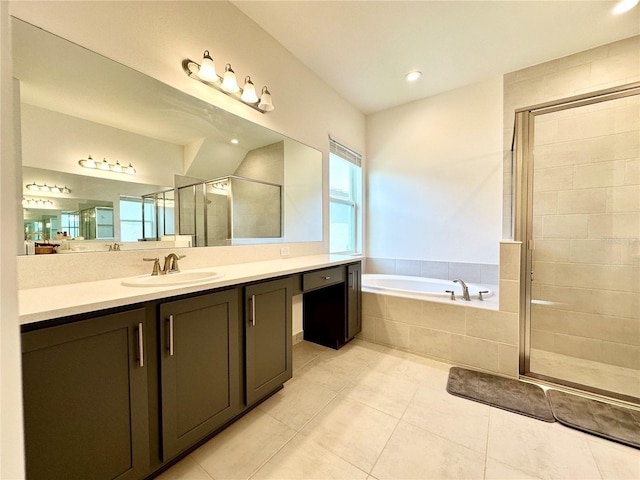 bathroom with a stall shower, vanity, a bath, and tile patterned floors