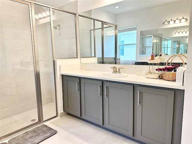 bathroom with a stall shower, tile patterned flooring, and vanity