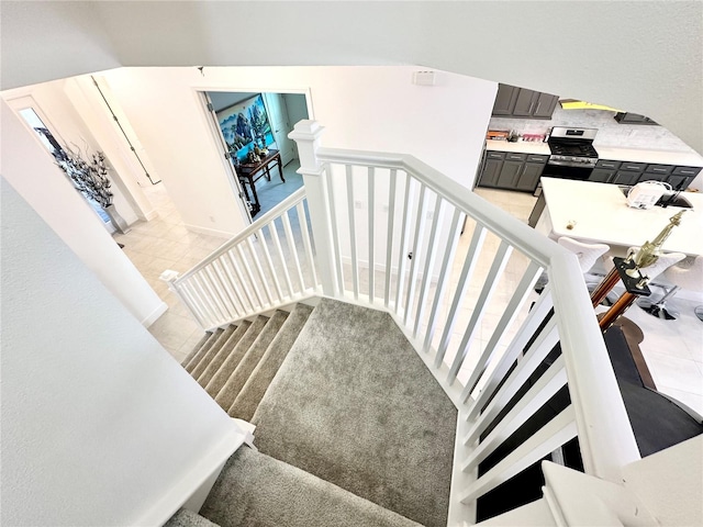 stairs featuring tile patterned flooring