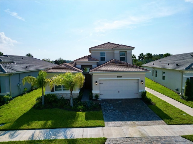 view of front facade with decorative driveway, stucco siding, an attached garage, stone siding, and a front lawn