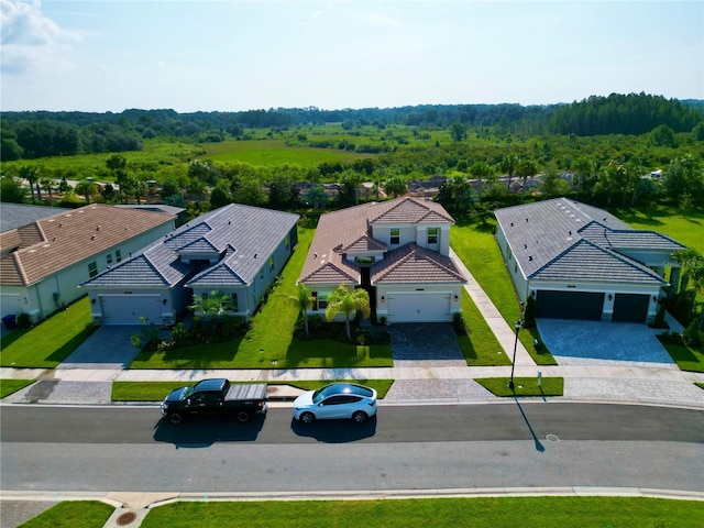 drone / aerial view featuring a wooded view