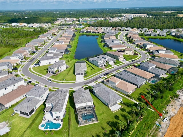 drone / aerial view with a residential view and a water view