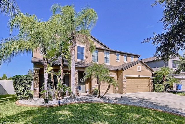 view of front of property with a garage and a front lawn