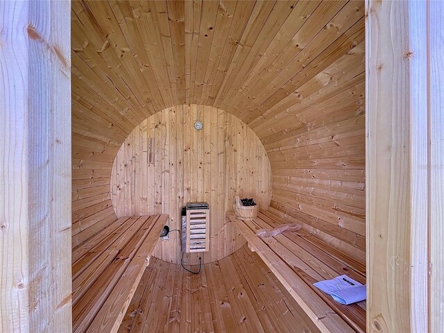 view of sauna / steam room with wooden ceiling and wooden walls