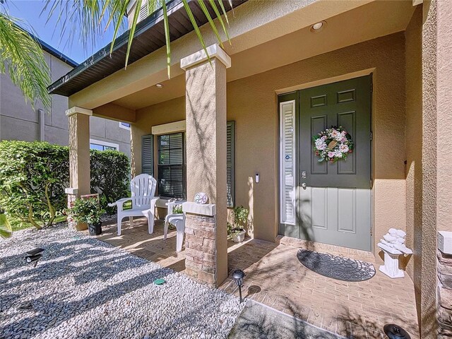 doorway to property with covered porch