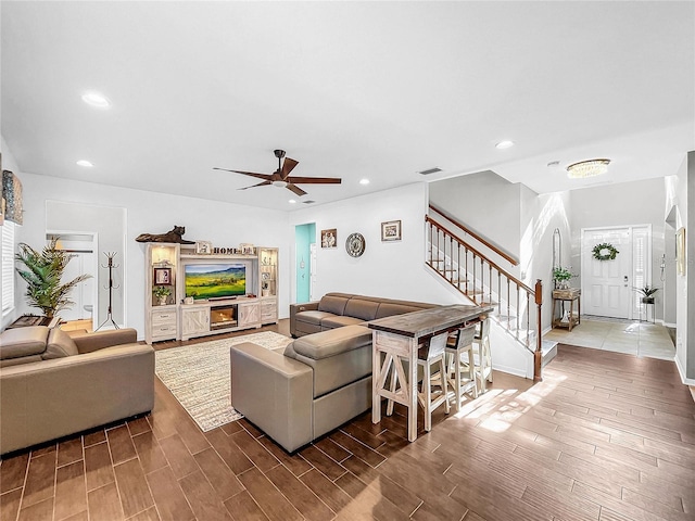 living room with ceiling fan and wood-type flooring