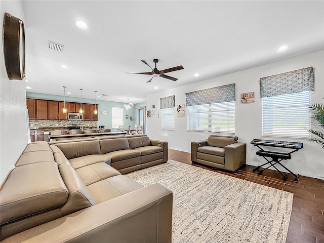 living room with ceiling fan and hardwood / wood-style floors