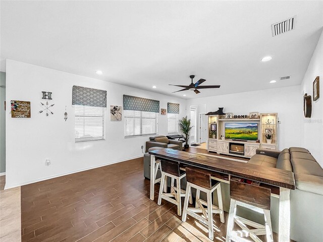 interior space with ceiling fan and dark hardwood / wood-style floors