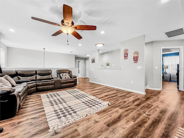 living room with hardwood / wood-style floors and ceiling fan