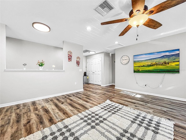 unfurnished living room featuring ceiling fan and hardwood / wood-style floors