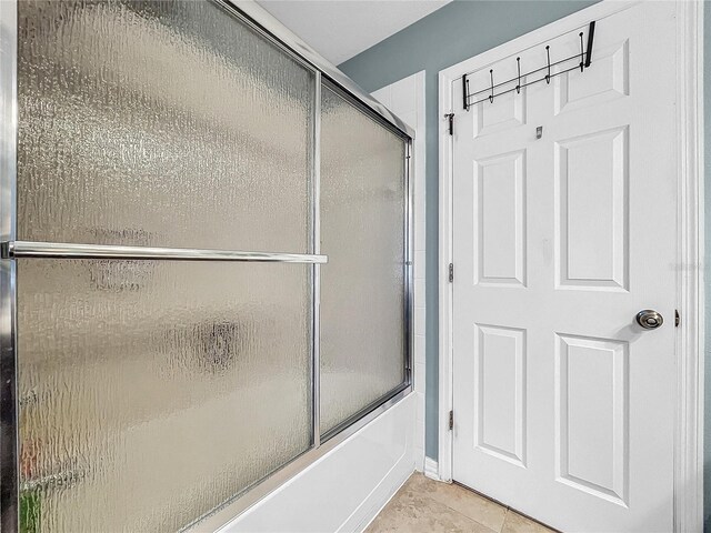 bathroom with tile patterned flooring and enclosed tub / shower combo