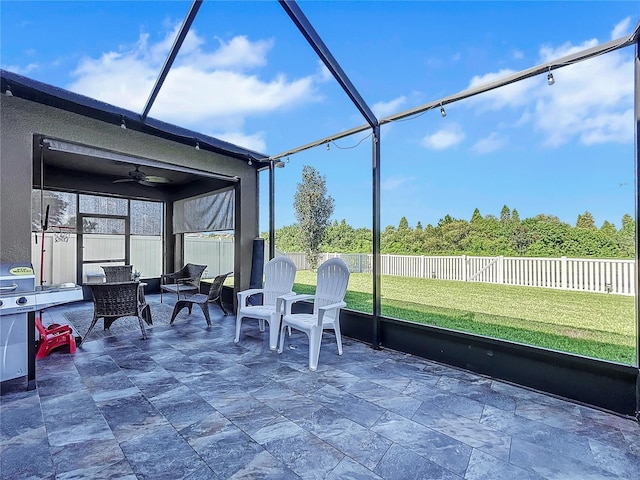 sunroom / solarium featuring ceiling fan