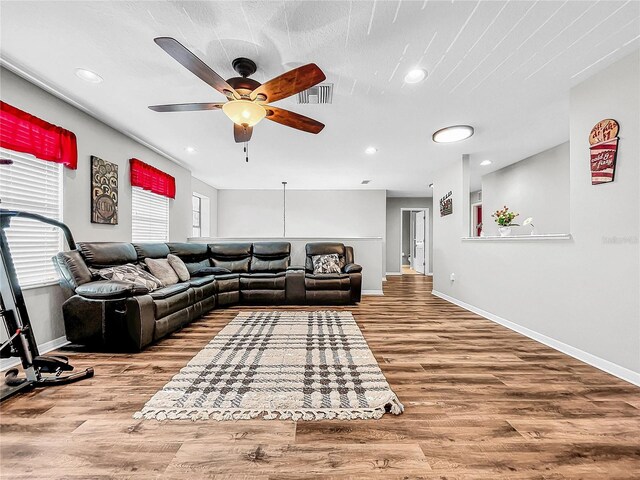 living room featuring ceiling fan and light wood-type flooring