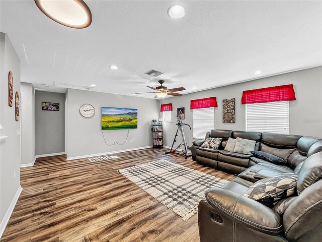 living room with ceiling fan and hardwood / wood-style flooring