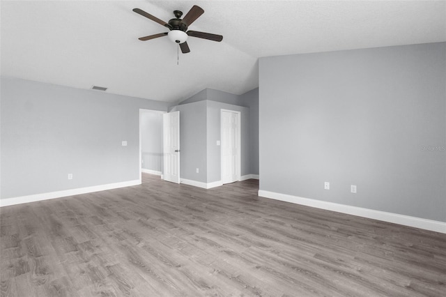 unfurnished living room featuring hardwood / wood-style floors, vaulted ceiling, and ceiling fan