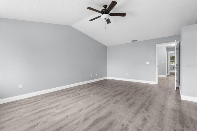 unfurnished room with ceiling fan, wood-type flooring, and lofted ceiling