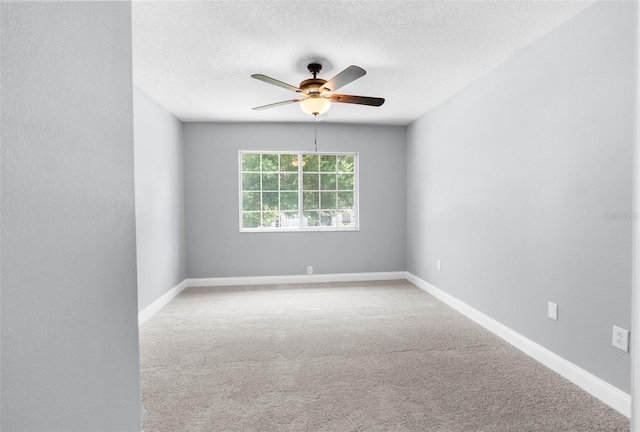 carpeted spare room with a textured ceiling and ceiling fan