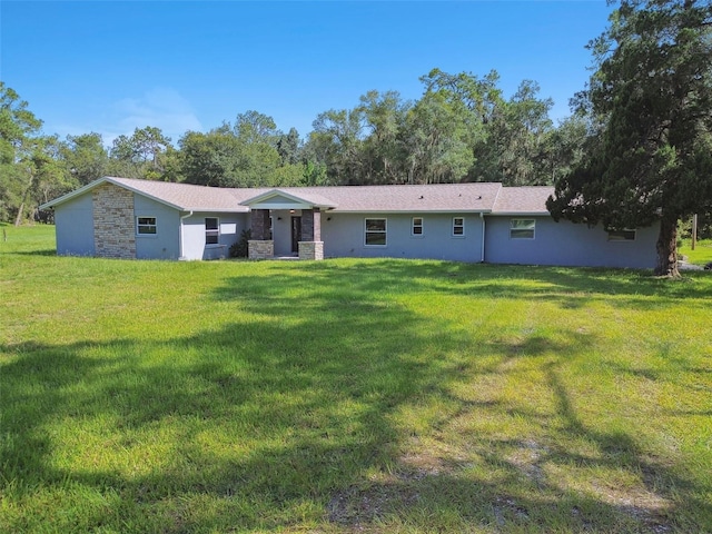 rear view of property featuring a yard