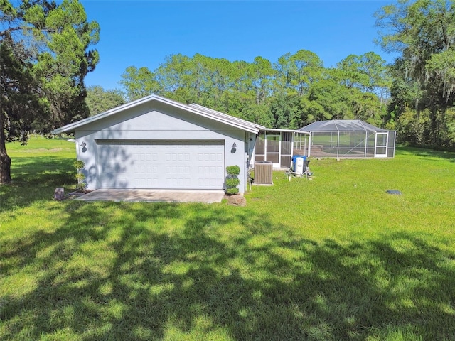 exterior space featuring glass enclosure, cooling unit, a garage, and a front yard