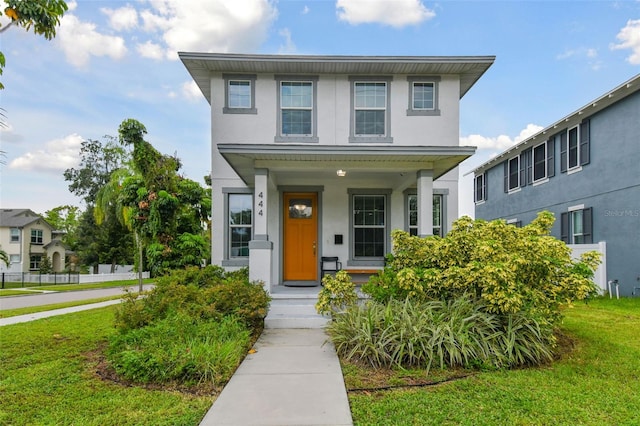 view of front of property with a porch and a front lawn