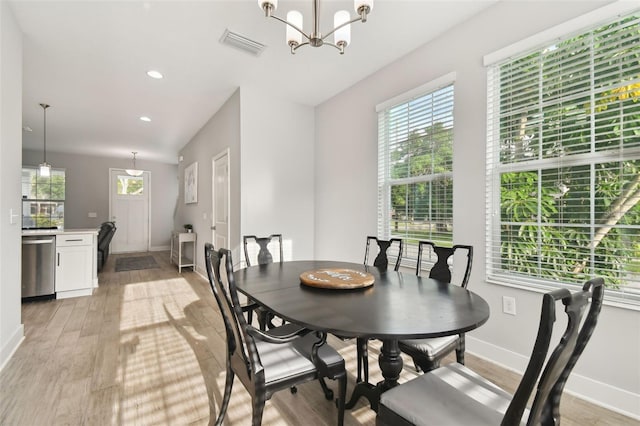 dining room featuring light hardwood / wood-style flooring and a chandelier