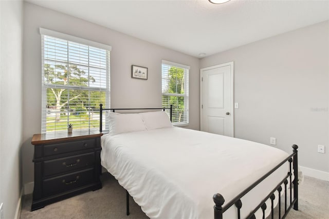 bedroom featuring light carpet