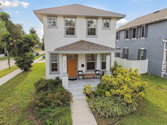 view of front of house featuring a front yard and a porch