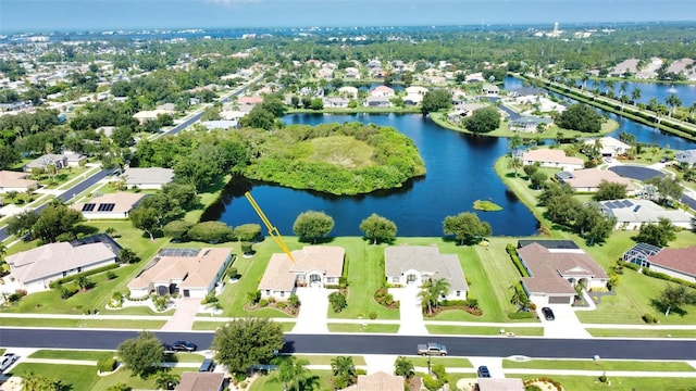 drone / aerial view with a water view and a residential view