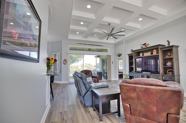 living area with a high ceiling, coffered ceiling, wood finished floors, baseboards, and beam ceiling