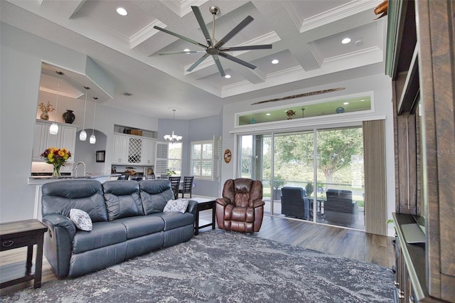 living area with a high ceiling, coffered ceiling, wood finished floors, ornamental molding, and beam ceiling