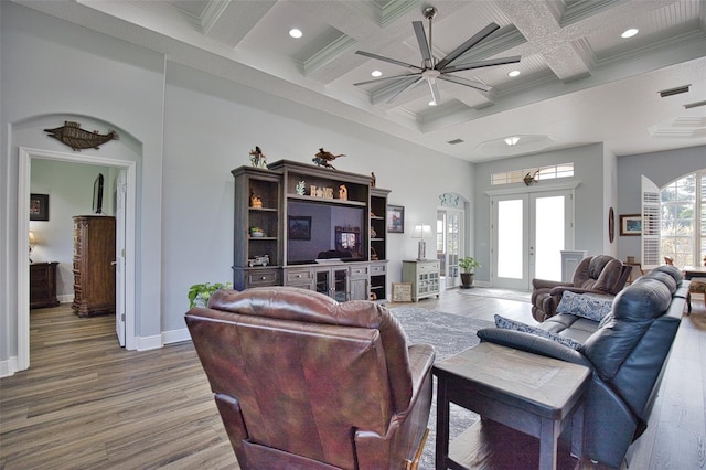 living area featuring french doors, beamed ceiling, wood finished floors, and baseboards