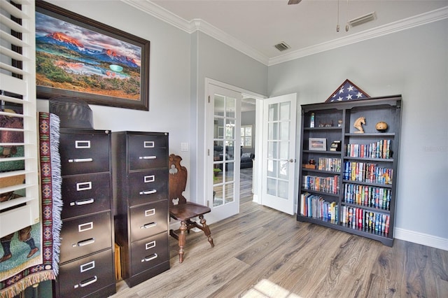 sitting room featuring visible vents, french doors, wood finished floors, and ornamental molding