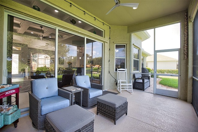 sunroom / solarium featuring a wealth of natural light and a ceiling fan