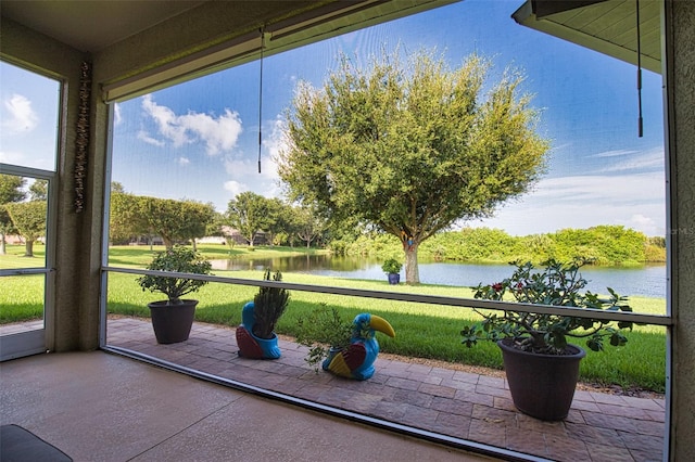 unfurnished sunroom featuring a water view