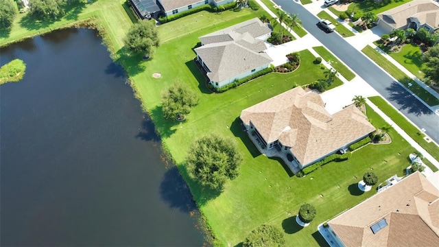 drone / aerial view with a water view and a residential view