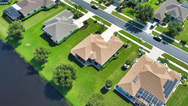 birds eye view of property with a water view and a residential view