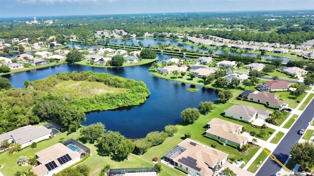 drone / aerial view with a residential view and a water view