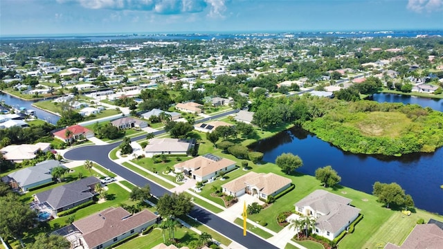 drone / aerial view featuring a residential view and a water view