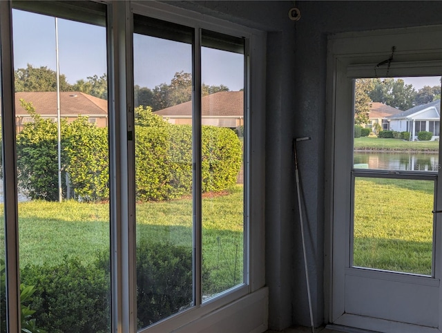 entryway with a wealth of natural light and a water view