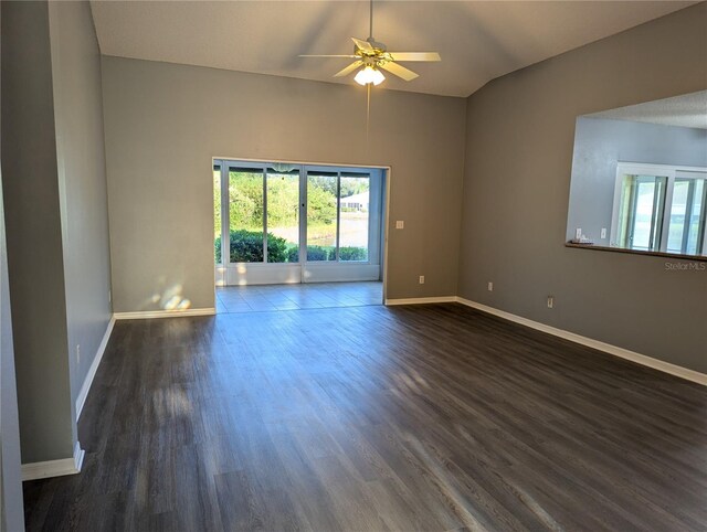 spare room with dark hardwood / wood-style flooring, ceiling fan, and lofted ceiling